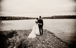On the shores front The Lake House Inn, a bride and groom.